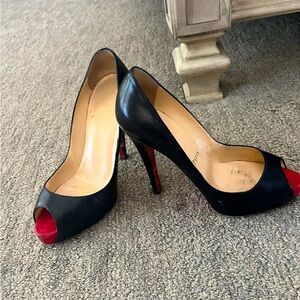 Christian Louboutin Black pumps; Originally $800; well worn